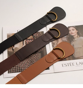 Detailed view of elastic wide belts with vintage metal D-buckles in three classic colors