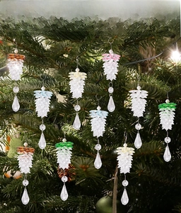 Close-up of multicolored acrylic pinecone ornaments hanging with crystal bead accents
