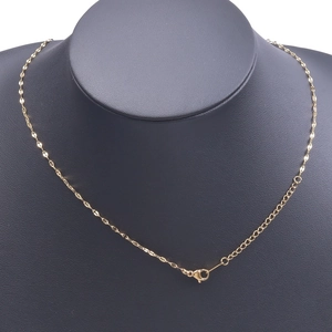 Detailed view of an 18k gold plated stainless steel necklace on a black mannequin