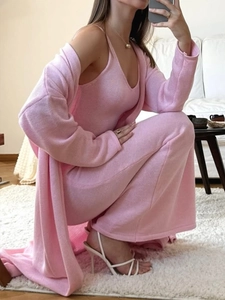 Detailed texture of pink knit long sleeve cardigan and matching midi dress set for women