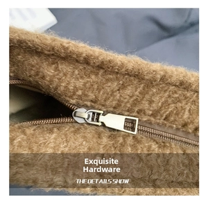 Detail of premium light gold metal zipper on brown wool texture shoulder bucket bag