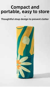 Compact rolled-up quick-dry beach towel with green yellow waves and daisy patterns