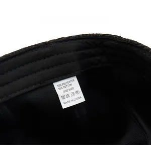 Care label detail of herringbone beret showing 50% cotton and 50% polyester material