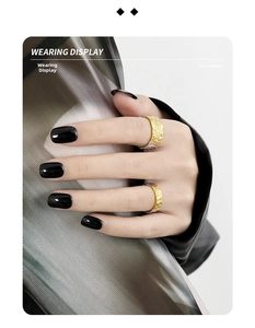 Detail view of irregular lava texture rings in gold and silver finish on a model's hand