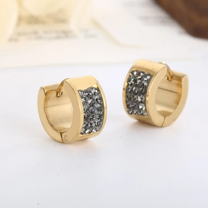 Close-up of gold-plated stainless steel earrings featuring sparkling grey rhinestones