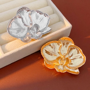 Detailed orchid flower brooches with realistic petal texture in silver and gold finish