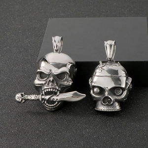 Detailed macro view of punk style mechanical skull pendants with gear and dagger motifs