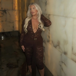 Macro detail of dark brown lace fabric and deep V-neck design on a stylish bodysuit
