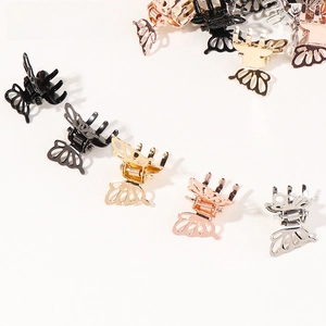 Macro detail of mini hollow butterfly metal hair claws in gold, silver and black colors