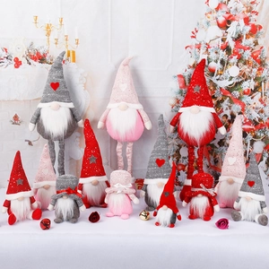 Plush Christmas gnomes with retractable legs in festive red and pink holiday decor