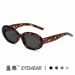 Vintage tortoiseshell oval sunglasses with dark lenses for a retro fashion aesthetic