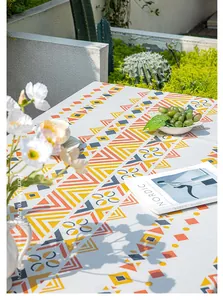 Close-up of Bohemian geometric waterproof tablecloth with vibrant tassels in outdoor garden