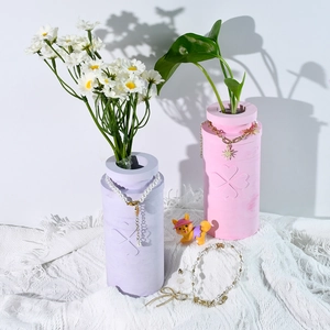 Detail of DIY epoxy resin four-leaf clover vases with pearl and star jewelry accents