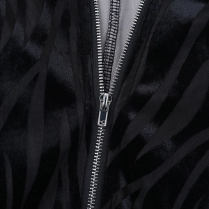 Detail of premium black velvet fabric texture with a high-quality silver metal zipper