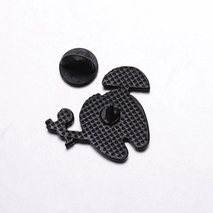 Detail of cartoon tooth brooch back showing zinc alloy texture and black rubber clutch