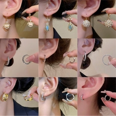 Detailed view of various elegant long tassel earrings and gold hoops for women