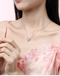 Close-up of S925 silver necklace with pink heart planet pendant worn by a model