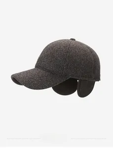 Detailed view of winter sport baseball cap with fold-down ear flaps and wool texture