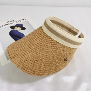 Detail view of woven sun visor with striped elastic band and gold-rimmed M letter badge