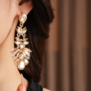 Gros plan de boucles d'oreilles vintage en or avec glands goutte d'eau et cristaux brillants