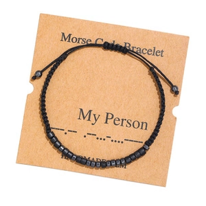Handmade Morse Code Bracelet with black beads on a My Person kraft display card