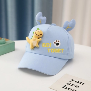 Detail of baby baseball cap with yellow 3D dinosaur patch and blue deer antlers