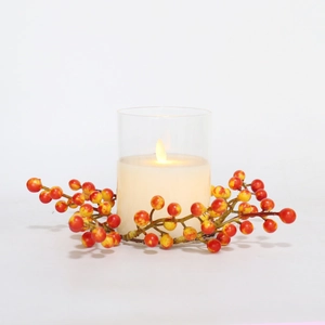 LED flameless candle in glass with autumn berry wreath for Halloween home decor