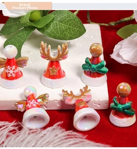 Macro view of iridescent Christmas beads showing angel, reindeer, and snowflake designs