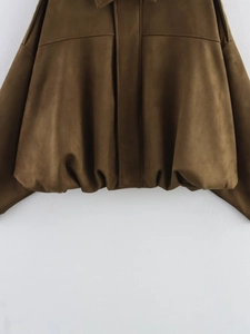 Detailed macro view of the elastic pleated hem on a dark brown suede bomber jacket