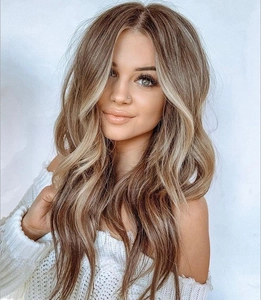 Detail shot of long wavy light brown ombre wig with blonde highlights for cosplay