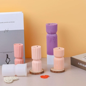 Symmetric ribbed cylinder silicone candle mold with colorful ripple textured wax pillars