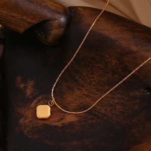 Minimalist 18K gold plated stainless steel necklace with square shell pendant on wood