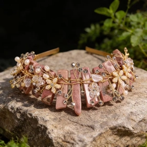 Detailed view of handmade pink crystal crown with floral beads and pearls on natural rock