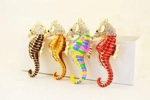 Detail view of colorful seahorse keychains featuring crystal rhinestones and enamel paint