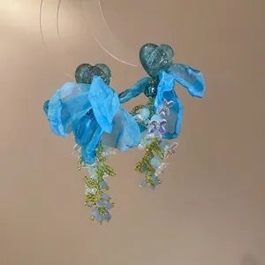 Elegant silver needle flower tassel earrings with blue fabric petals and crystals