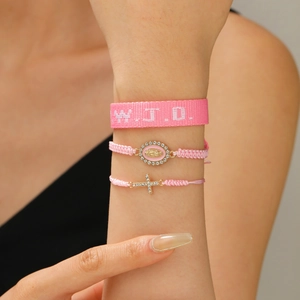 Pink WWJD ribbon and woven bracelets set with rhinestone cross and virgin mary charms