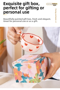 Detailed view of handmade wavy ceramic heart mug with colorful floral gift packaging