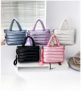 Detailed view of quilted cotton shoulder bags in five colors on minimalist display