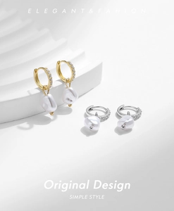 Detail of elegant S925 silver hoop earrings with baroque pearls and zircon inlay