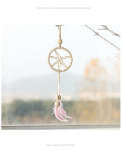 Detail of dreamcatcher ornament with pink feathers and wood beads for Christmas