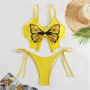 Flat lay of yellow butterfly print bikini set with straw hat and sunglasses beach accessories