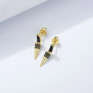 Macro detail of S925 sterling silver cone earrings with black zircon in punk style