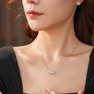 Gros plan détaillé du collier papillon en zircon et des boucles d'oreilles assorties