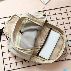 Minimalist beige backpack with large capacity and organized compartments for laptops