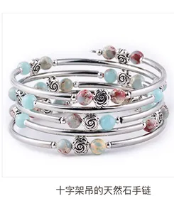 Detail of multi-layer wrap bracelet with natural turquoise stones and silver rose accents