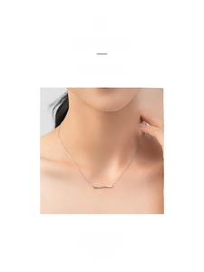 Detail of S925 sterling silver necklace with cursive mama letter pendant on a model
