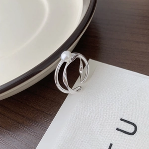 Detailed macro view of S925 silver double-layered open ring with a white pearl