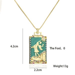 Macro detail of a 18K gold-plated tarot necklace pendant with dimensions and green Fool design