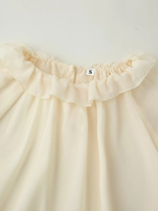 Detail of ruffle neckline on beige chiffon blouse showing high-quality stitching and size S