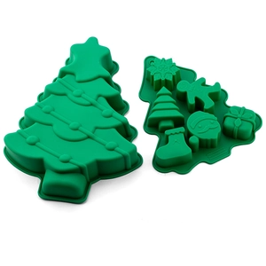 Detailed view of green silicone Christmas molds featuring tree, snowflake, and gingerbread man